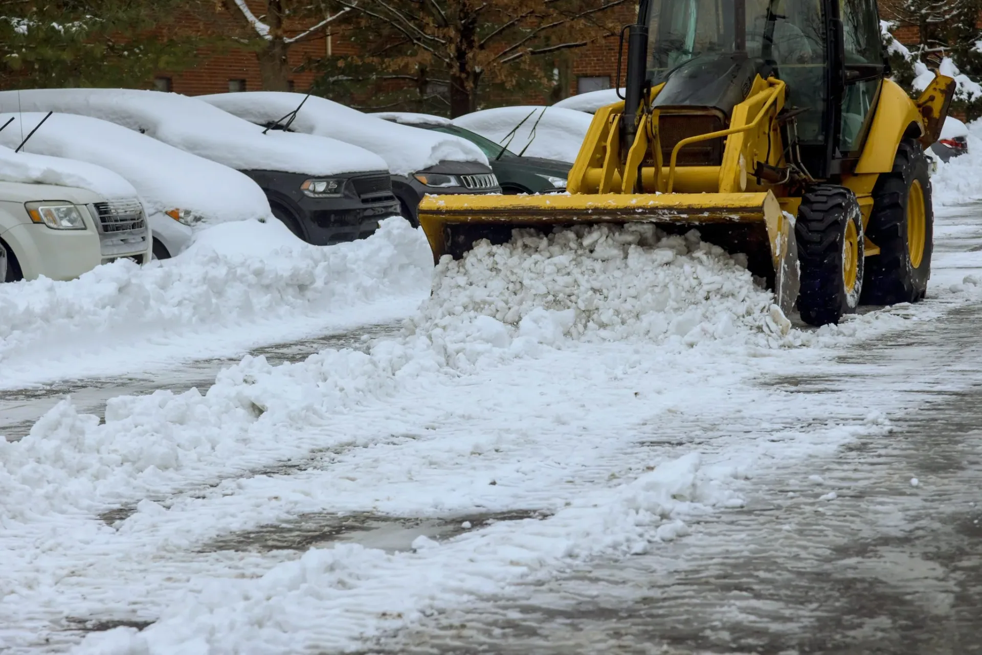 An,Icebreaker,Truck,Removes,Snow,From,Parking,Lot,Following,Heavy